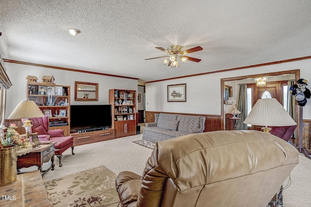 2554 Davis Mill Rd, Fremont, NC 27830 - carpeted living room with ornamental molding, a wainscoted wall, a textured ceiling, and ceiling fan