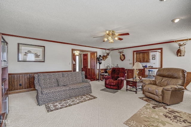 2554 Davis Mill Rd, Fremont, NC 27830 - living area featuring carpet, a textured ceiling, crown molding, a ceiling fan, and a wainscoted wall