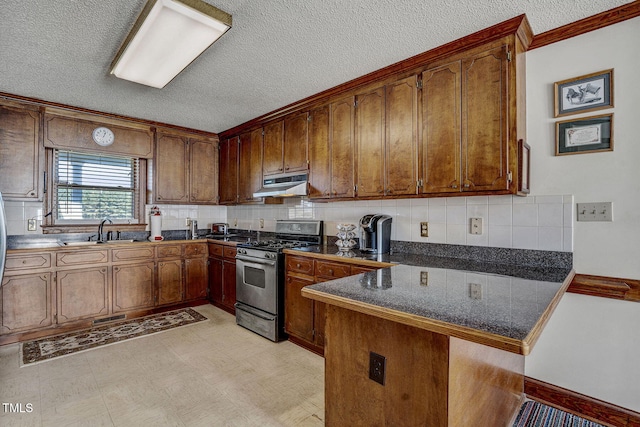 2554 Davis Mill Rd, Fremont, NC 27830 - kitchen with gas stove, under cabinet range hood, a peninsula, brown cabinets, and decorative backsplash