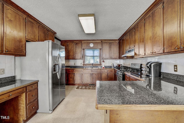 2554 Davis Mill Rd, Fremont, NC 27830 - kitchen featuring appliances with stainless steel finishes, exhaust hood, a sink, a textured ceiling, and decorative backsplash