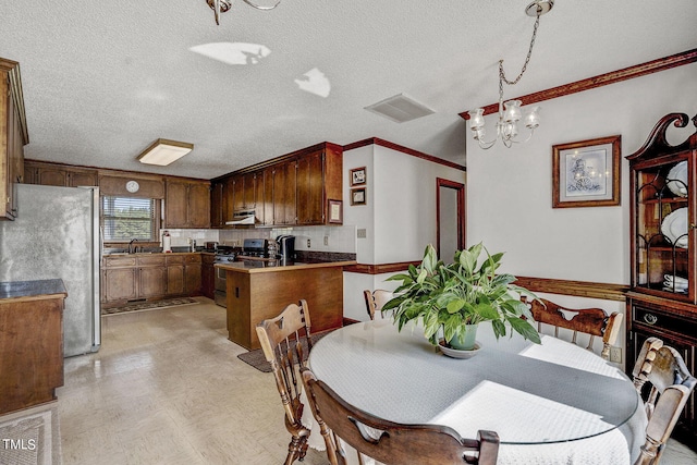 2554 Davis Mill Rd, Fremont, NC 27830 - dining room featuring light flooring, a chandelier, ornamental molding, and a textured ceiling