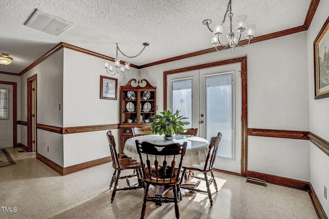2554 Davis Mill Rd, Fremont, NC 27830 - dining room featuring a chandelier, healthy amount of natural light, baseboards, a textured ceiling, and crown molding