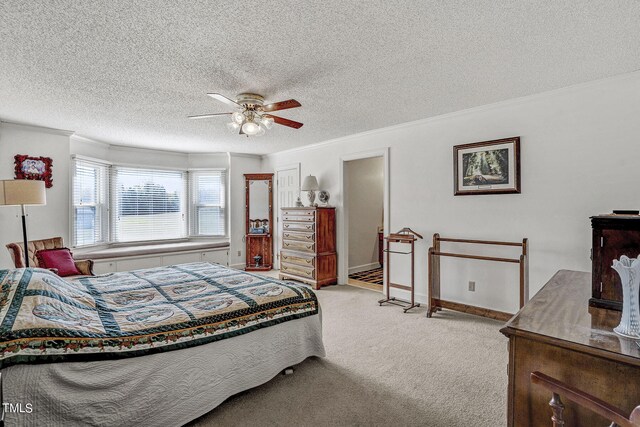 2554 Davis Mill Rd, Fremont, NC 27830 - bedroom with carpet, crown molding, a textured ceiling, a ceiling fan, and baseboards