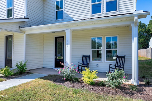 view of exterior entry featuring covered porch