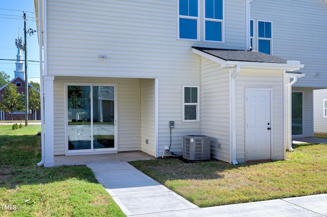 exterior space with a yard and central AC