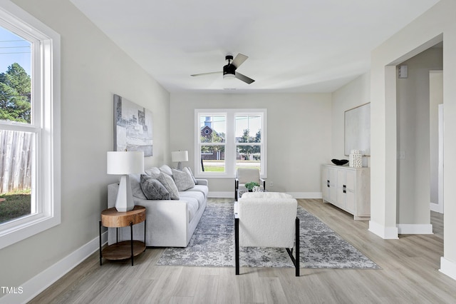 living room featuring light hardwood / wood-style flooring and ceiling fan