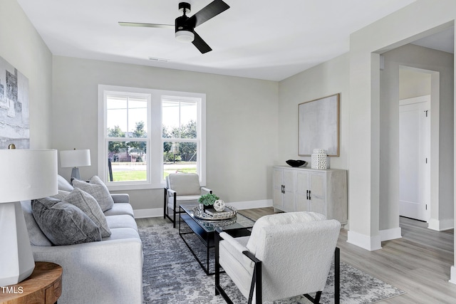 living room featuring hardwood / wood-style flooring and ceiling fan