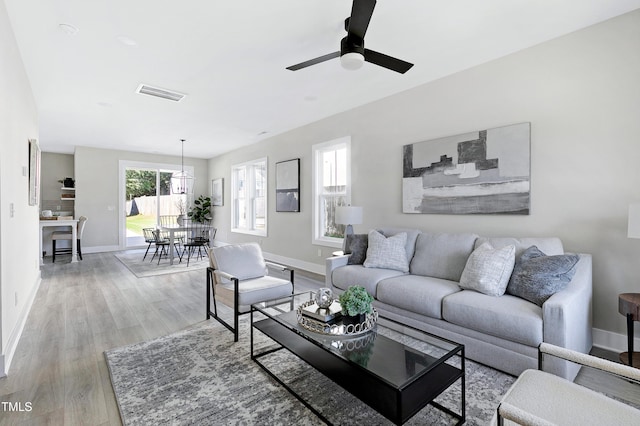 living room featuring light hardwood / wood-style floors and ceiling fan