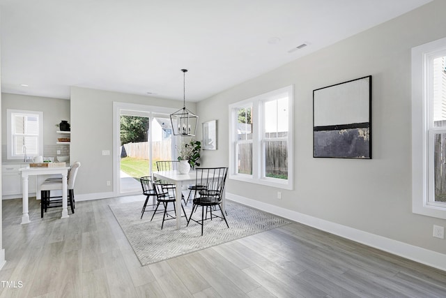 dining room featuring light hardwood / wood-style floors and an inviting chandelier