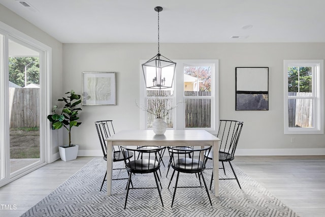 dining area with light hardwood / wood-style floors and plenty of natural light