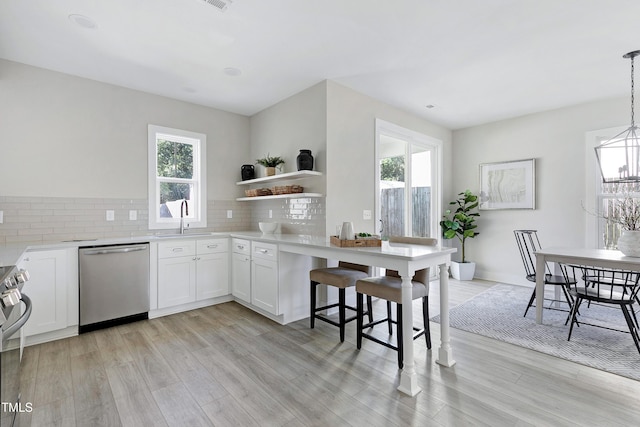 kitchen with white cabinetry, a healthy amount of sunlight, and stainless steel appliances