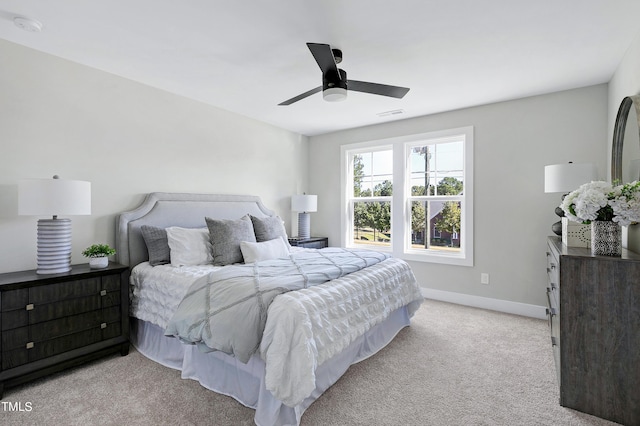 bedroom with light colored carpet and ceiling fan