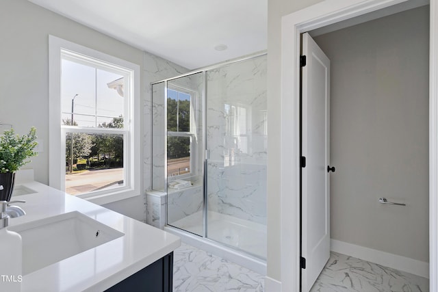 bathroom featuring a shower with door and vanity