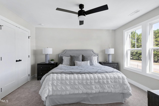 carpeted bedroom with a closet and ceiling fan