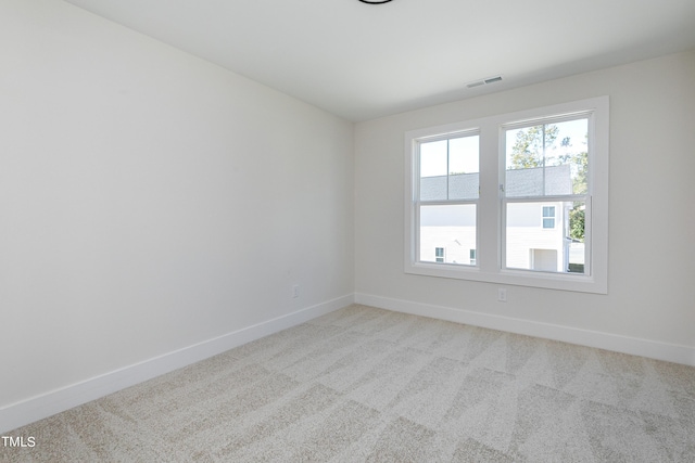 empty room featuring light colored carpet