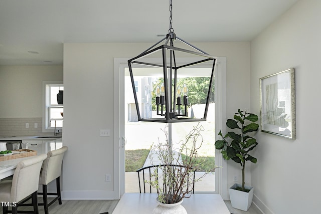 dining area with light hardwood / wood-style flooring and sink