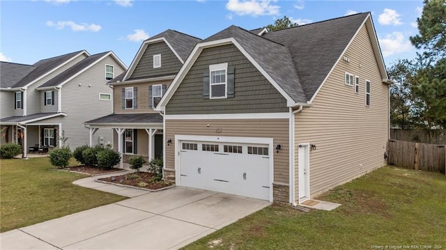 craftsman-style house featuring a front yard and a garage