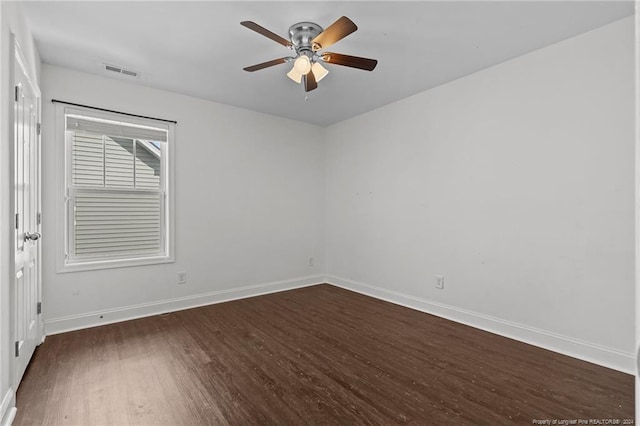 spare room featuring ceiling fan and dark hardwood / wood-style flooring