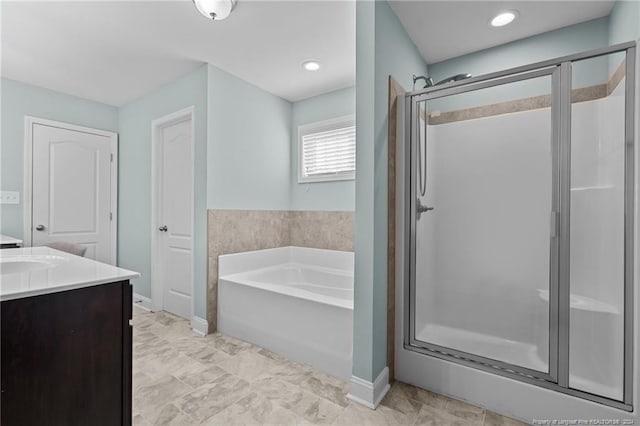 bathroom featuring vanity and shower with separate bathtub