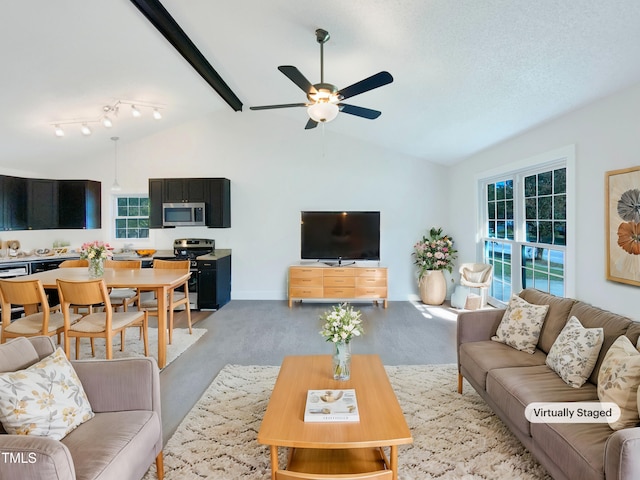 carpeted living room with beamed ceiling, high vaulted ceiling, and ceiling fan