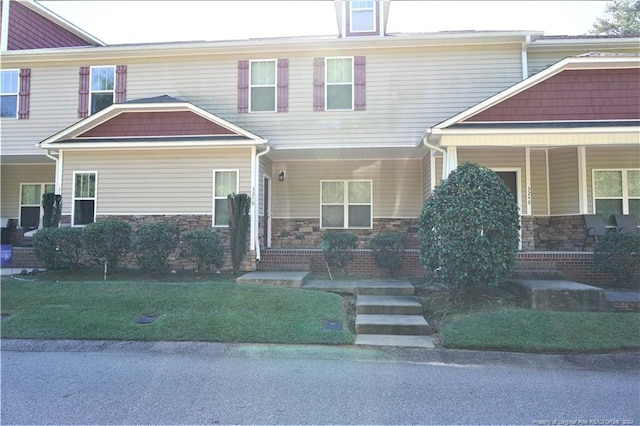 craftsman inspired home with covered porch and a front yard