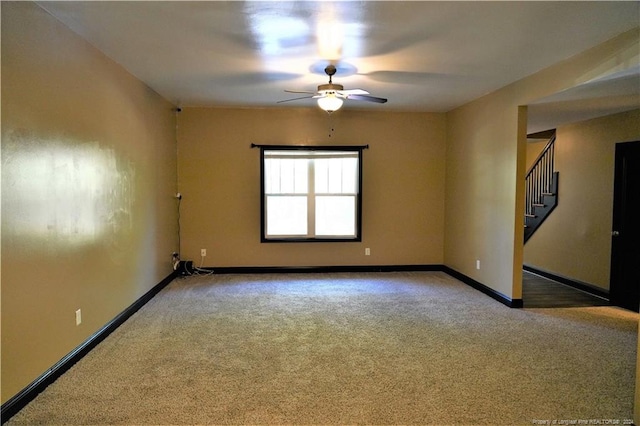 empty room featuring carpet flooring and ceiling fan