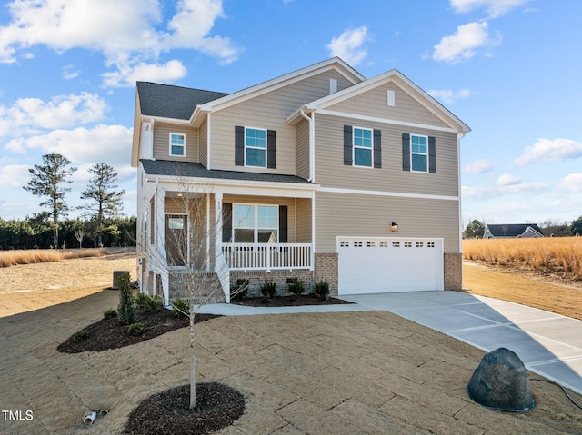 craftsman inspired home featuring a porch, a garage, and driveway