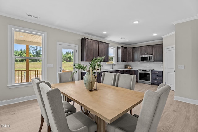 15 Diamond Creek Dr, Zebulon, NC 27597 - dining space with crown molding, light wood-type flooring, and recessed lighting