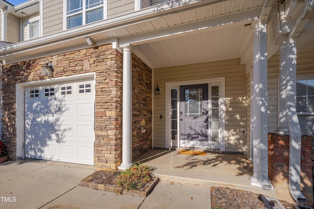 entrance to property with a garage and covered porch