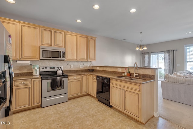 kitchen with sink, kitchen peninsula, appliances with stainless steel finishes, decorative light fixtures, and a notable chandelier