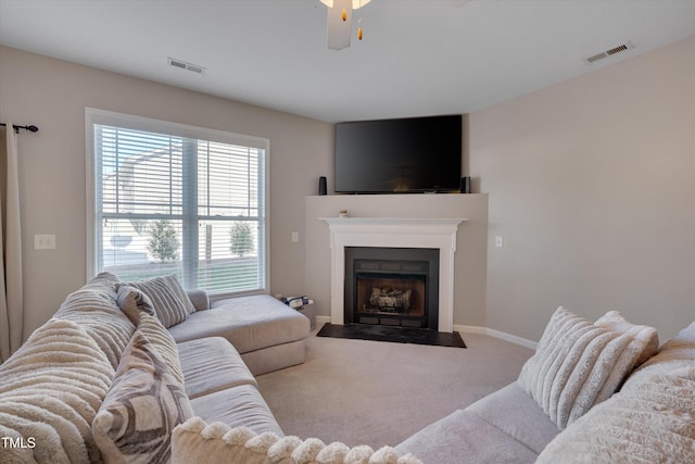 carpeted living room featuring ceiling fan