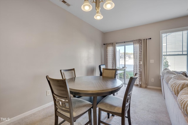 carpeted dining room featuring lofted ceiling