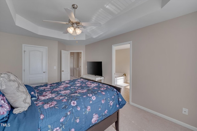 carpeted bedroom featuring ceiling fan and a raised ceiling