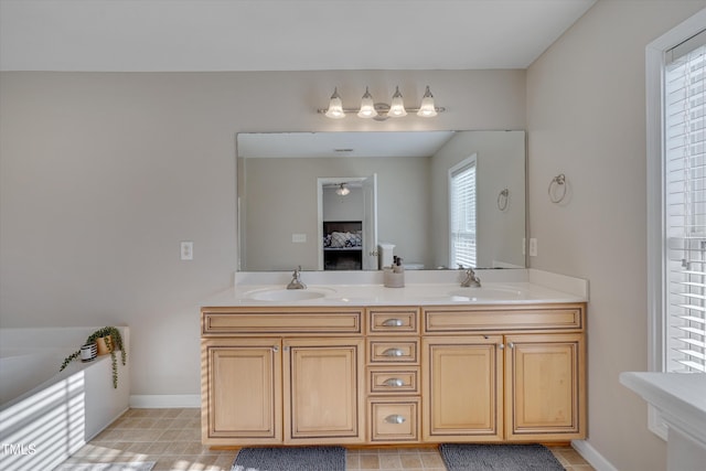 bathroom featuring a tub to relax in and vanity