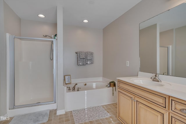 bathroom with vanity and shower with separate bathtub