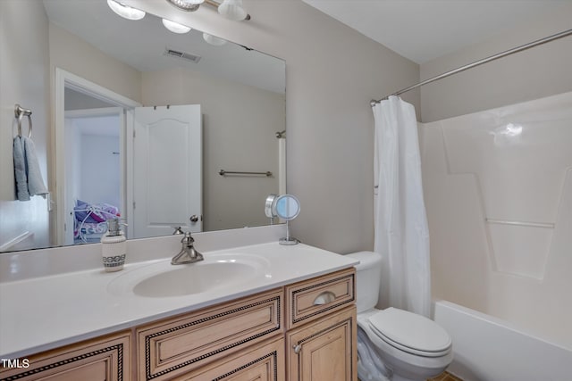 full bathroom with vanity, shower / bath combination with curtain, and toilet