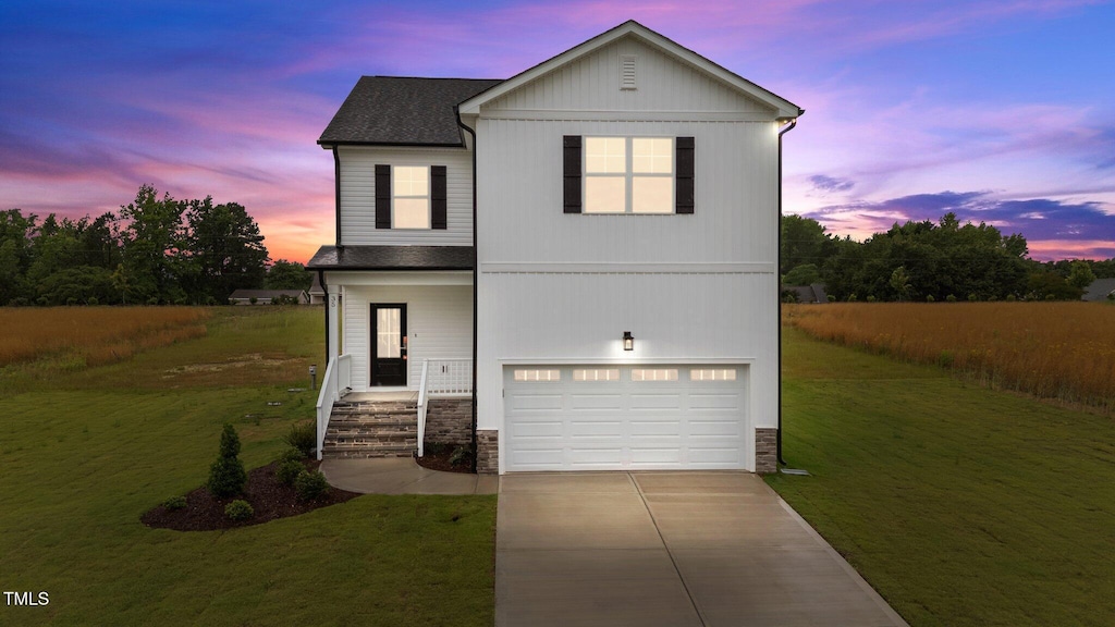 35 Diamond Creek Dr, Zebulon, NC 27597 - view of front of home with an attached garage, concrete driveway, a front yard, and stone siding