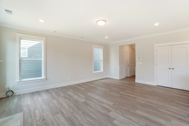 unfurnished bedroom featuring crown molding and light hardwood / wood-style flooring