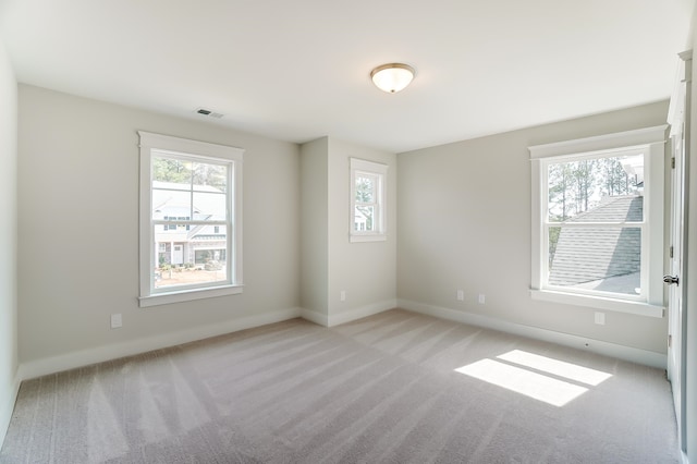 spare room with light colored carpet