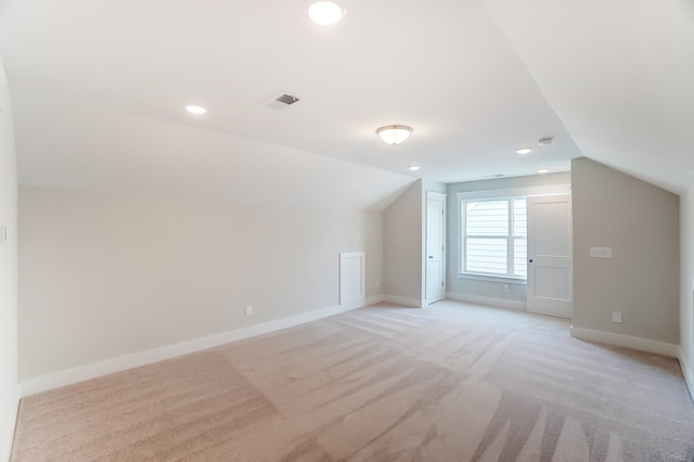 bonus room featuring light carpet and vaulted ceiling