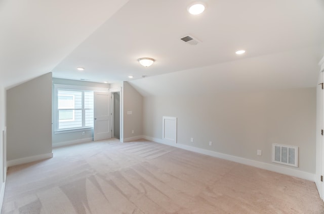 additional living space with lofted ceiling and light colored carpet