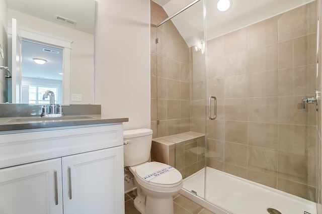 bathroom with toilet, an enclosed shower, vanity, and tile patterned flooring