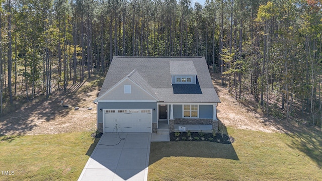 view of front of home with a front yard, a garage, and covered porch