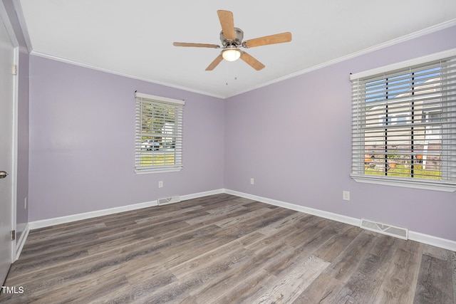 spare room with crown molding, ceiling fan, and dark hardwood / wood-style flooring