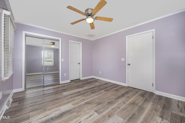 unfurnished bedroom with ceiling fan, wood-type flooring, and ornamental molding