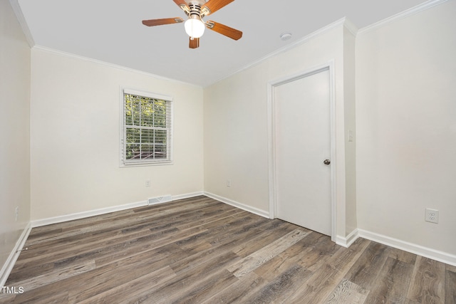 unfurnished room with crown molding, dark wood-type flooring, and ceiling fan