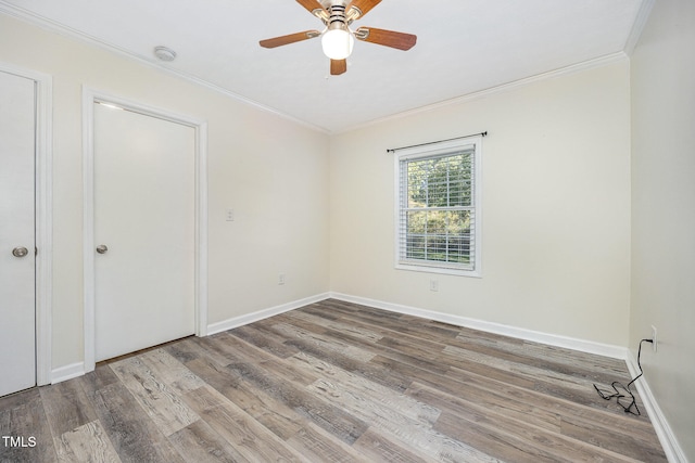 unfurnished bedroom featuring ceiling fan, crown molding, and hardwood / wood-style floors