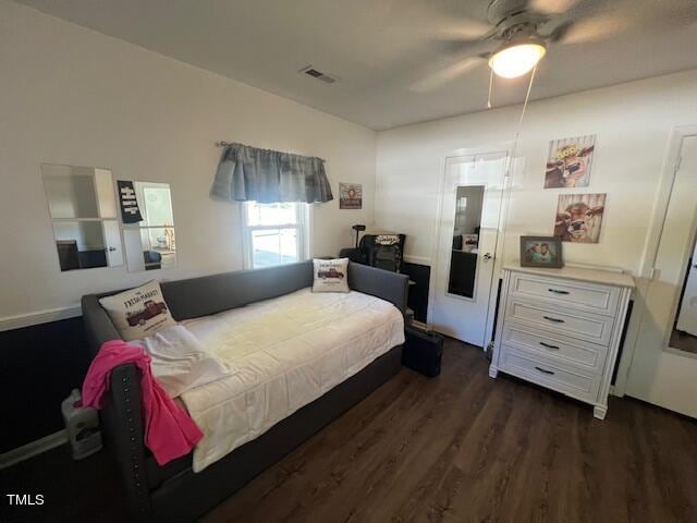 bedroom featuring ceiling fan and dark hardwood / wood-style floors