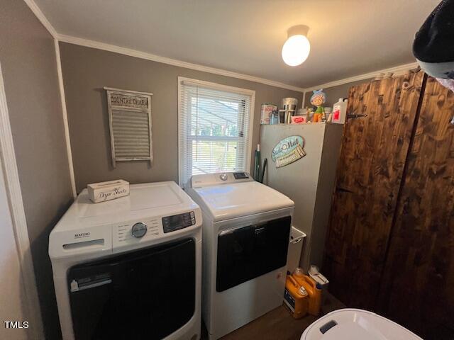 laundry room with separate washer and dryer and crown molding