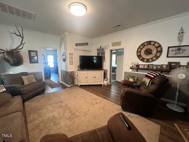 living room with dark hardwood / wood-style floors and crown molding